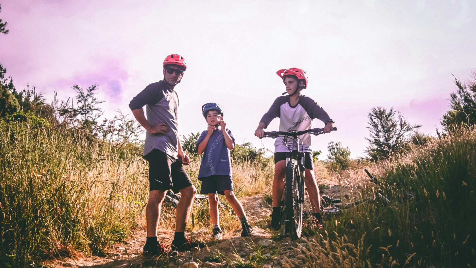 A family enjoys mountain biking on a scenic trail, capturing an adventurous outdoor moment.