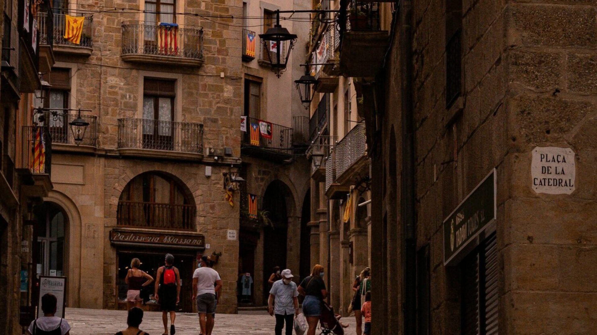 Charming cobblestone street scene in Solsona, Spain with historic architecture and tourists exploring.